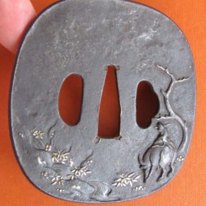 T297. Large Iron Tsuba. Man playing flute on ox