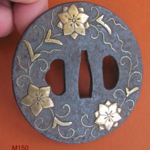 M150. Iron with brass inlay tsuba