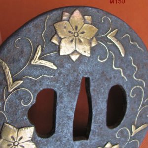 M150. Iron with brass inlay tsuba