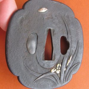 M183. Iron tsuba with gold, silver, and copper applied