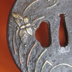 T165. Iron tsuba with soft metal butterflies