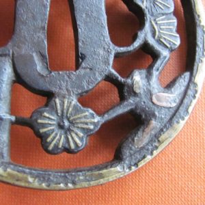 T418. Iron Sukashi Tsuba with Extensive Brass Inlay