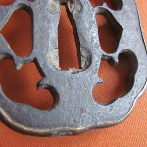 T419. Iron Sukashi Tsuba with Copper Fukurin