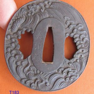 T183. Finely carved iron tsuba signed Yoshiaki with Kao