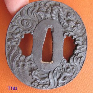 T183. Finely carved iron tsuba signed Yoshiaki with Kao