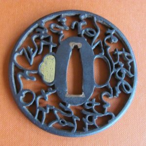 T498. Iron Sukashi Tsuba, Grass Script