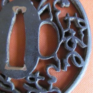 T498. Iron Sukashi Tsuba, Grass Script